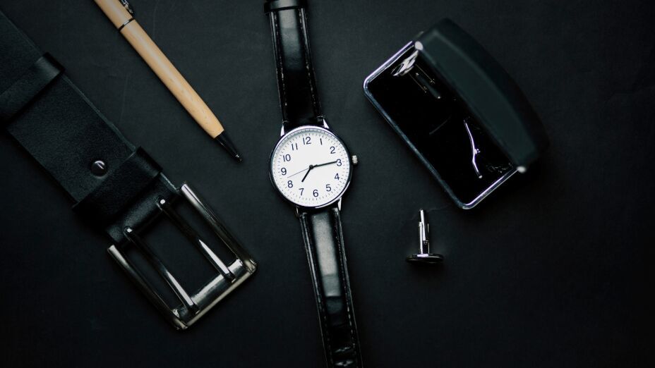 Close-up of men's fashion accessories, including silk ties, cufflinks, and leather watches for a polished look.