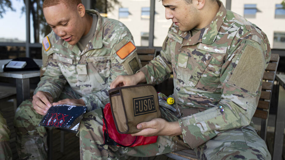 USO volunteers pack care-package kits destined for deployed troops on Armed Forces Day.