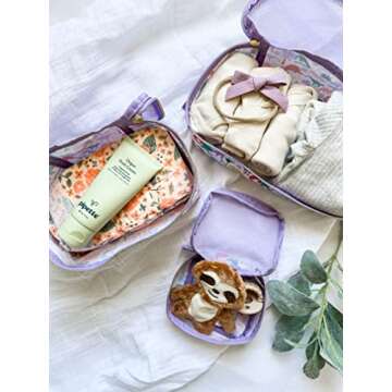 Itzy Ritzy Packing Cubes For Travel – Set of 3 Packing Cubes or Travel Organizers; Each Travel Cube Features a Mesh Top, Double Zippers and a Fabric Handle (Purple Dinosaurs)