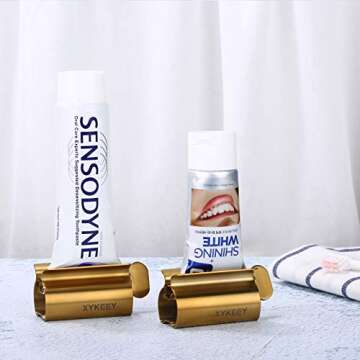 XYKEEY Toothpaste Tube Squeezer - Set of 2 Toothpaste Squeezer Rollers, Metal Toothpaste Tube Wringer Seat Holder Stand (Matt Gold)