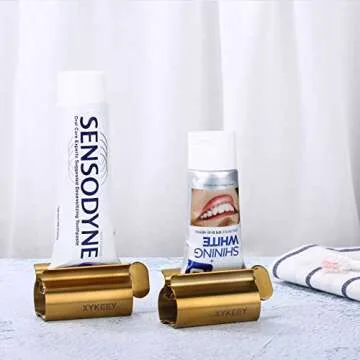 XYKEEY Toothpaste Tube Squeezer - Set of 2 Toothpaste Squeezer Rollers, Metal Toothpaste Tube Wringer Seat Holder Stand (Matt Gold)