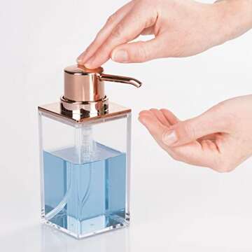 mDesign Plastic Bathroom Vanity Countertop Accessory Set - Includes,Soap Dispenser, Toothbrush Holder, Lidded Canister, and Tumbler Rinsing Cup; Lumiere Collection - Set of 4 - Clear/Rose Gold