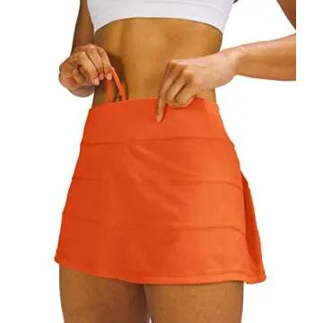 MEIVSO Women's Pleated Workout Tennis Skirts with Pockets Activewear Sports Skort Built-in Shorts (Orange, X-Small)