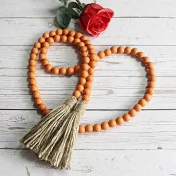 CVHOMEDECO. Wood Beads Garland with Tassels Farmhouse Rustic Wooden Prayer Bead String Wall Hanging Accent for Home Festival Decor. Orange