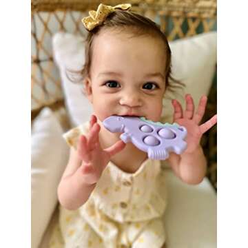 Itzy Ritzy Sensory Popper Toy for Babies - Itzy Pop Toy Features Raised Textures to Soothe Sore Gums, Relieve Stress & Improve Motor Skills - Baby & Toddler Fidget Toy for 3 Mo. & Up (Purple Dinosaur)