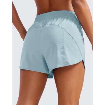 CRZ YOGA Women's High Waisted 3'' Running Shorts with Mesh Liner and Zip Pocket in Light Grayish Blu...