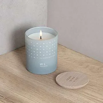 Skandinavisk ØY 'Island' Scented Candle. Fragrance Notes: Crabapple and Dog Rose, Water Mosses and Green Leaves. 7.0 oz.