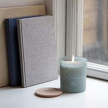 Skandinavisk ØY 'Island' Scented Candle. Fragrance Notes: Crabapple and Dog Rose, Water Mosses and Green Leaves. 7.0 oz.