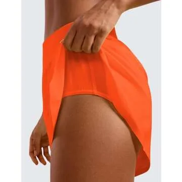 CRZ YOGA Mid Waisted Dolphin Athletic Shorts for Women 4" Lightweight High Split for Gym Workout with Liner Quick Dry Neon Orange Medium