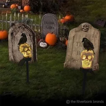 the Riverbank Brands Scary Glowing Skull & Crow Solar Pathway Lights with Glow in The Dark Eyes, Creepy Outdoor Halloween Decorations, Set of 2 Pathway & Driveway Markers