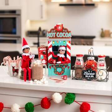 The Elf on the Shelf Insta-Props 2-in-1 Scene Kit with Reversible Pop Out Backdrop - Hot Cocoa Stand and Magic Shrinking Machine Scenes with Accessories