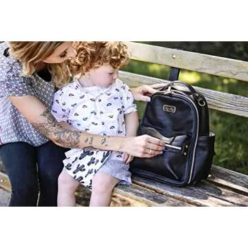 Itzy Ritzy Mini Diaper Bag Backpack – Chic Mini Diaper Bag with Changing Pad, 8 Total Pockets (4 Internal and 4 External), Grab-Top Handle and Rubber Feet (Black)