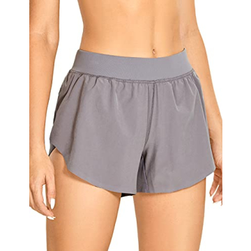 CRZ YOGA Women's Mid Rise Dolphin Running Shorts Quick Dry Lightweight Split Liner Breathable Athlet...