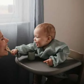 mushie Long Sleeve Baby Bib | Mess Free & Waterproof Fabric for Toddlers | Adjustable Fit for Ages 6-24 Months (Roman Green)